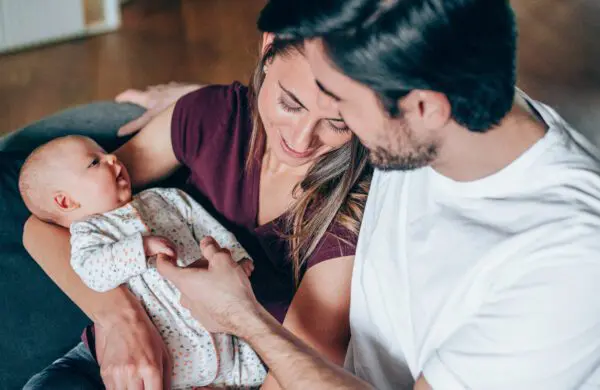 Young couple enjoying the company of each other and their newborn baby