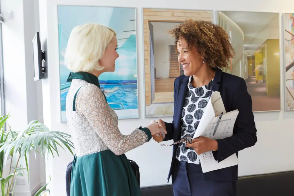 Two women shaking hands