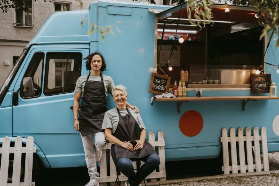 workers sitting outside a food truck