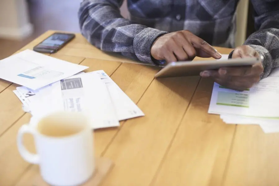 Anonymous hands using digital tablet to surf the net for better deals