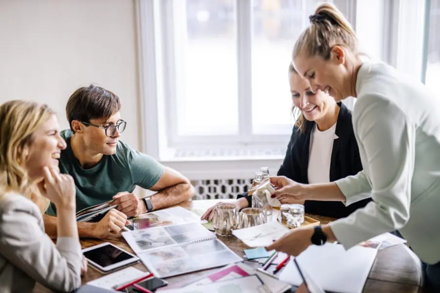 Smiling customers and event planners discussing at office