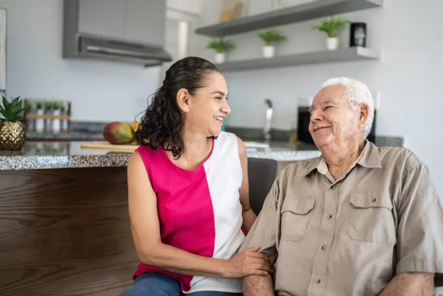 Senior man and his daughter talking at home