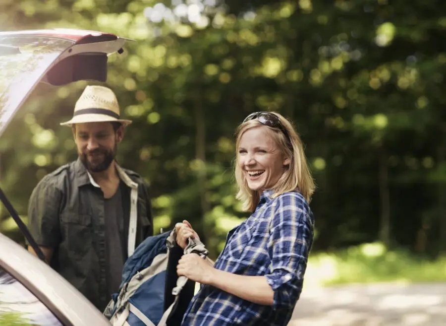 Young couple packing car