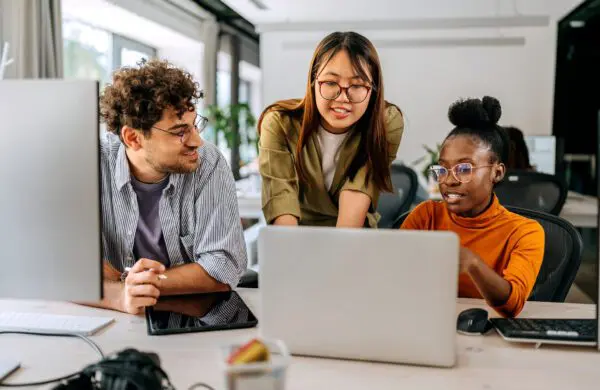 Three young colleagues discussing work at modern office