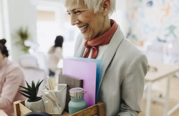 Businesswoman packing personal company belongings after deciding on a resignation or change of job and completing offboarding