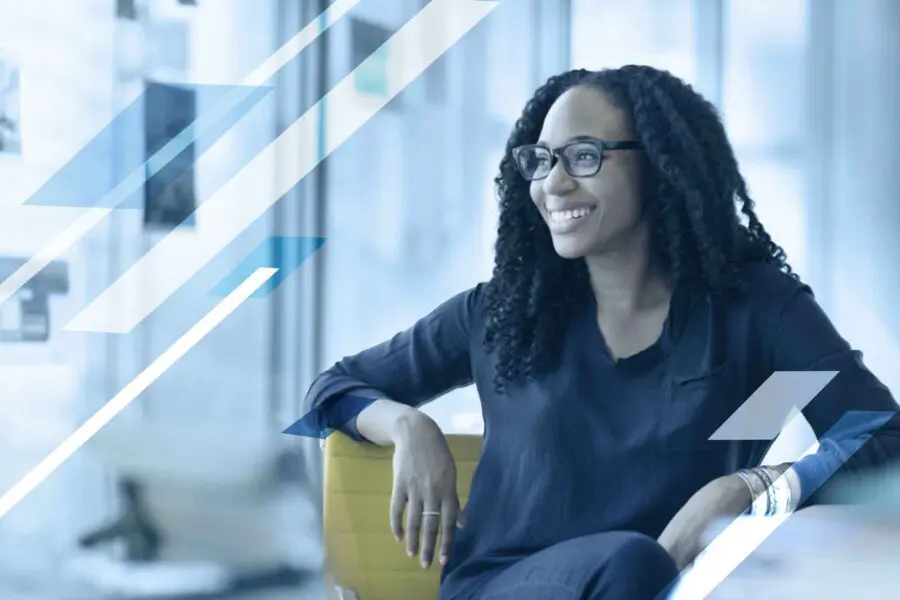 WomanWithGlassesSittingInAnOfficeChair