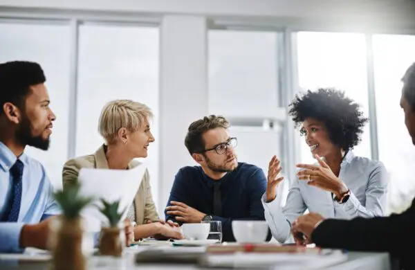 Business professionals engaged in a discussion at a table in their office