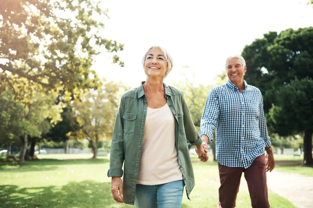 Image of a happy senior couple going for a walk in the park