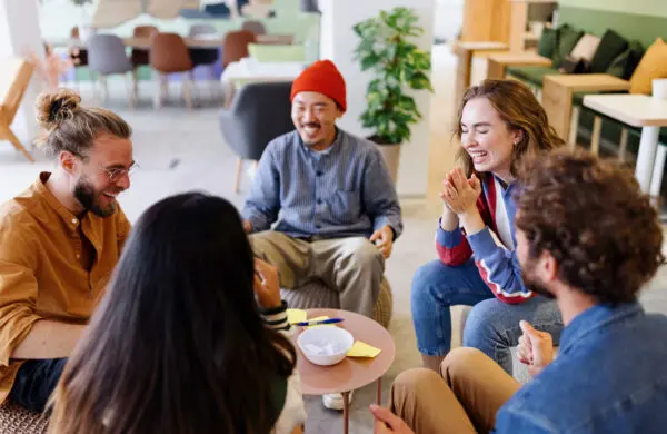 Group of smiling coworkers playing leisure games during a team building exercise in the workplace