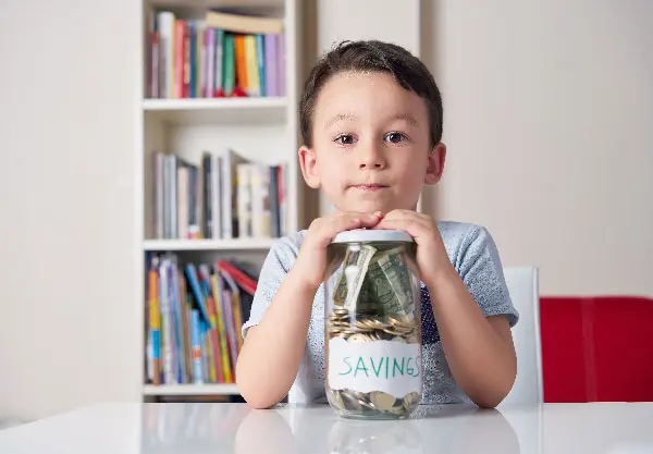 Kid holding jar full of money