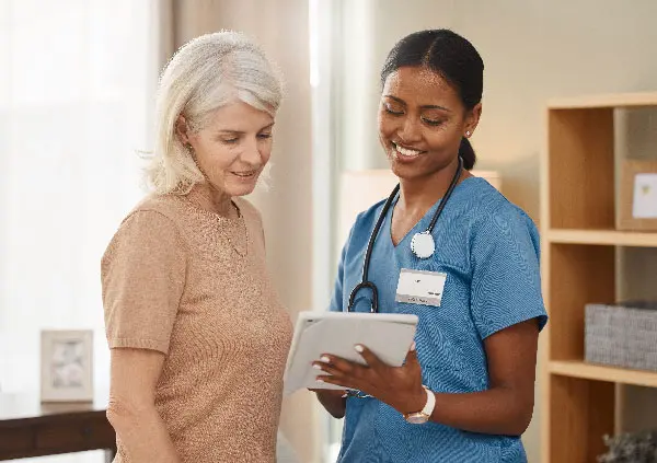 Nurse showing paperwork to patient