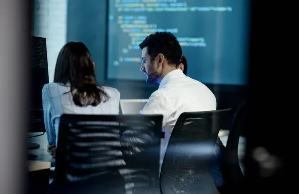 Business professionals perform software testing in a technology startup office