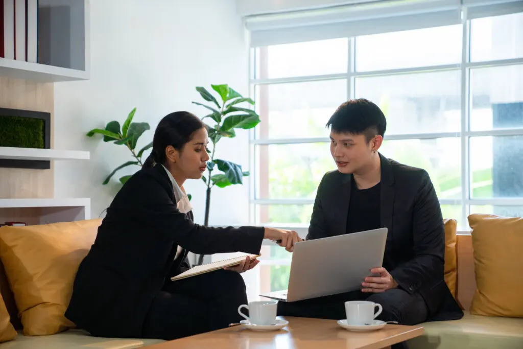 Female insurance advisor consulting with a client about contract and other business documents