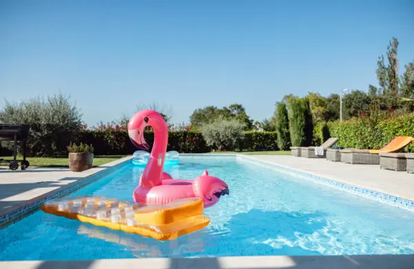 Colorful pool floats floating on the water of the empty swimming pool