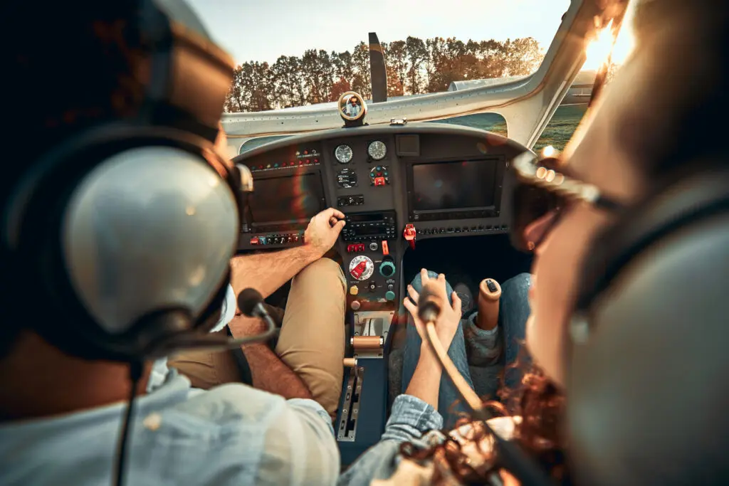 Rear view of pilot and copilot in private cockpit of small airplane
