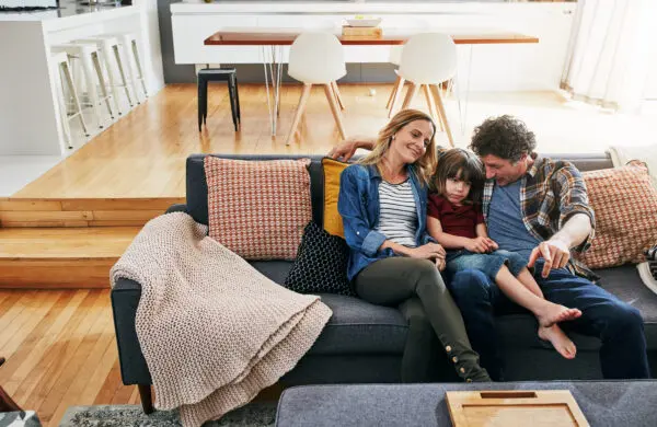 Cropped shot of an affectionate family of three relaxing on the sofa at home