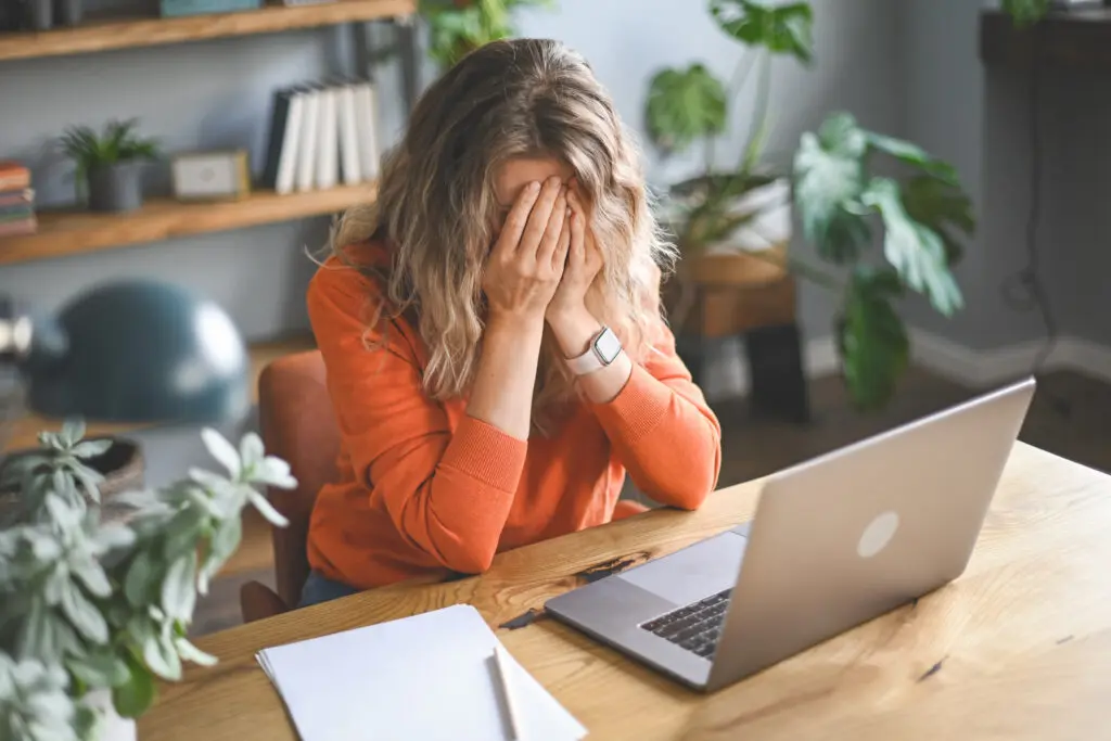 Adult woman upset and frustrated while working at home