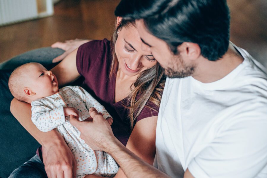 Young couple enjoying the company of each other and their newborn baby