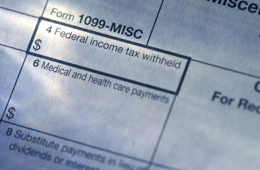 Close-up of a 1099-MISC form, crucial for 1099 contractors, showing sections for "Federal income tax withheld" and "Medical and health care payments," highlighting the importance of accurate worker classification.