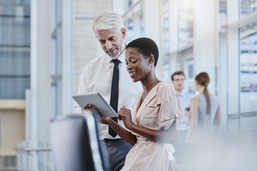 Businessman And Businesswoman With Digital Tablet