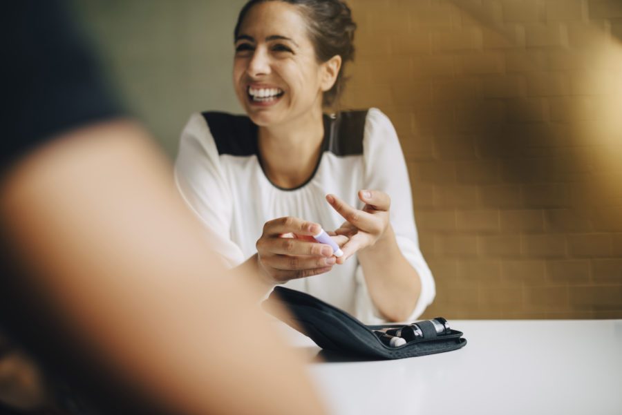 Smiling-businesswoman-at-conference-room-table