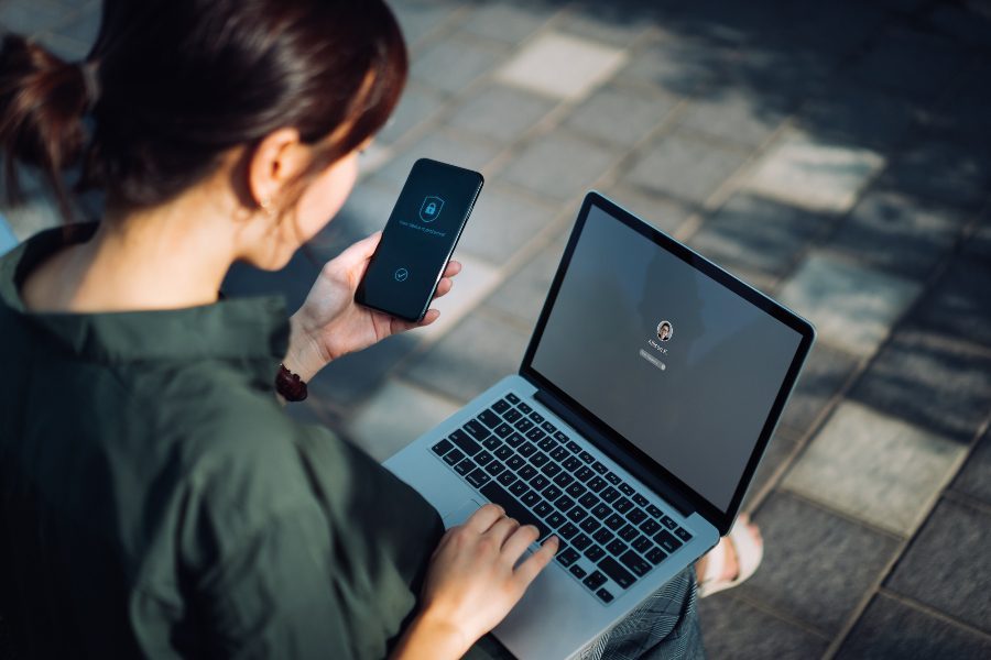 woman-looking-at-phone-and-computer