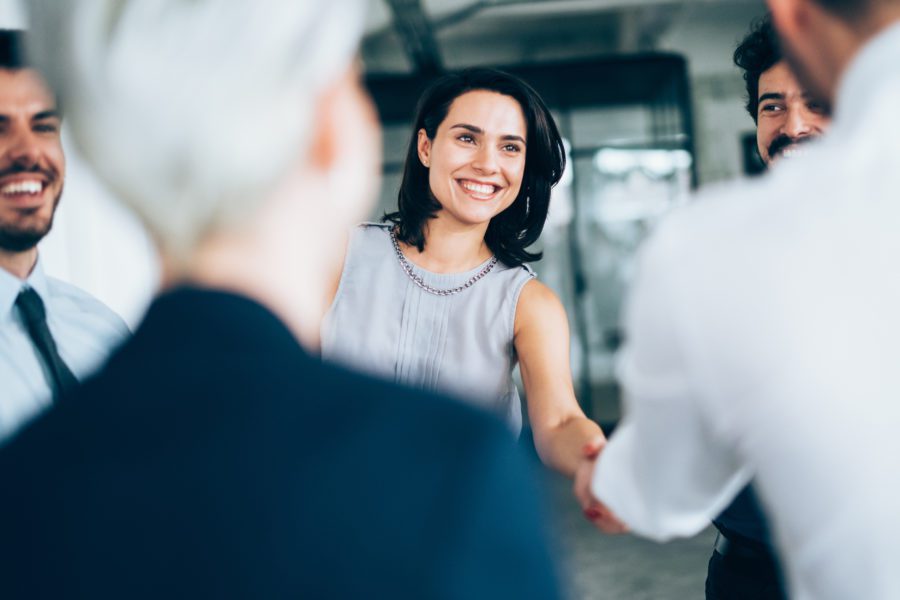 woman-shaking-hands-before-retirement-plan-meeting