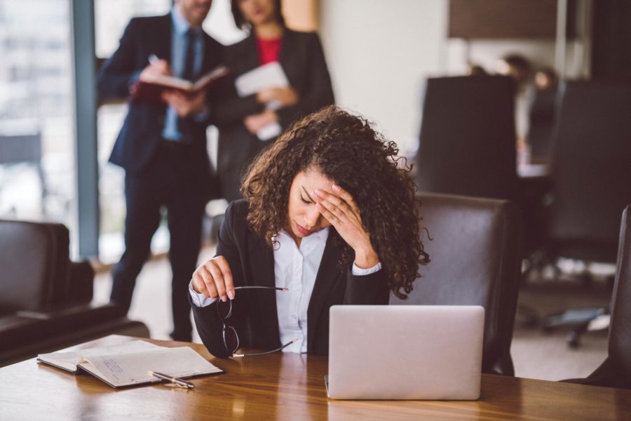 Annoyed employee sitting at a desk