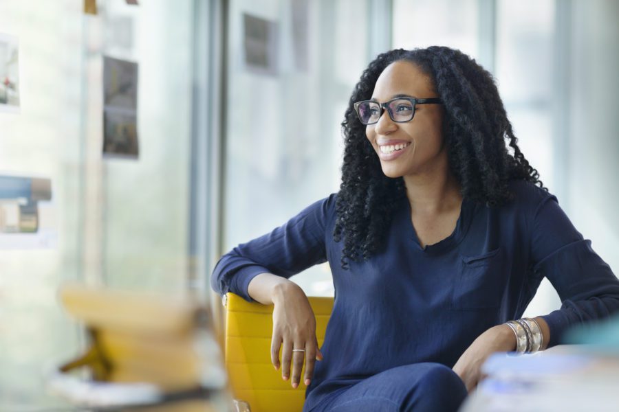 Woman looking sideways to window in design office