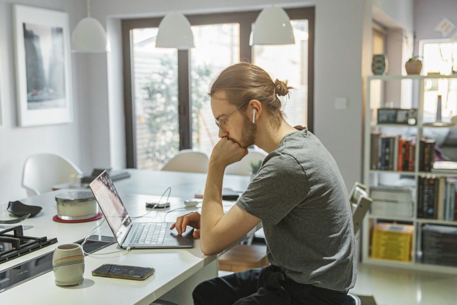 Man working on side hustles from home