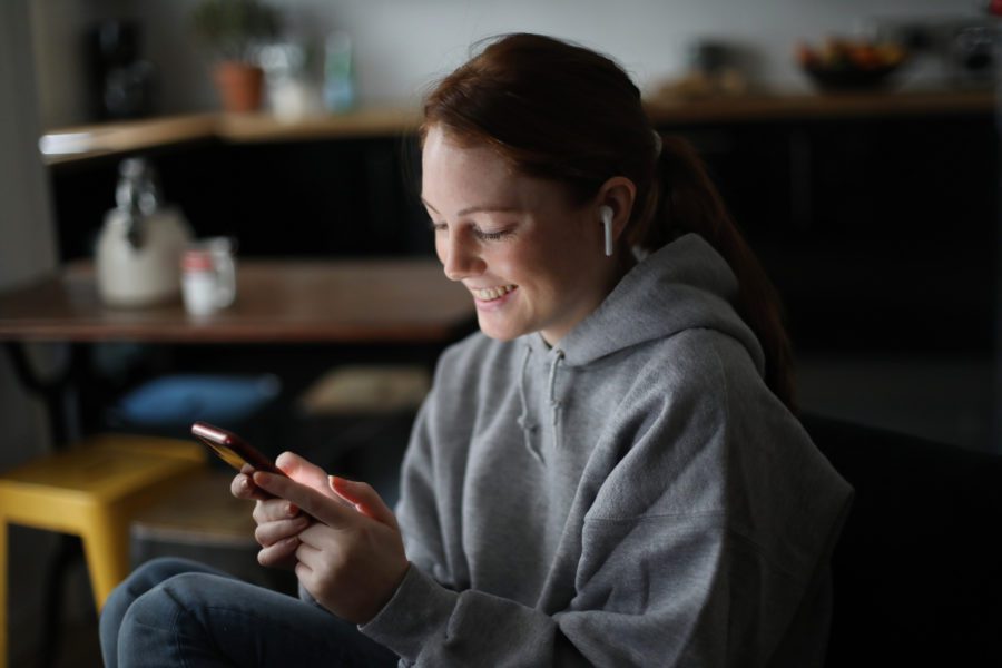 Young woman smiling at phone