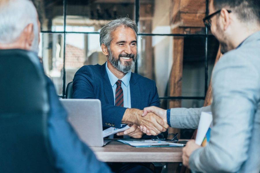 Two men shaking hands in meeting