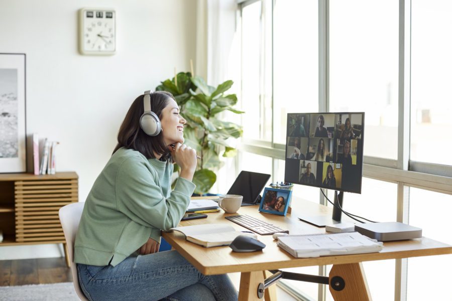 Woman attending a virtual business meeting while working from home