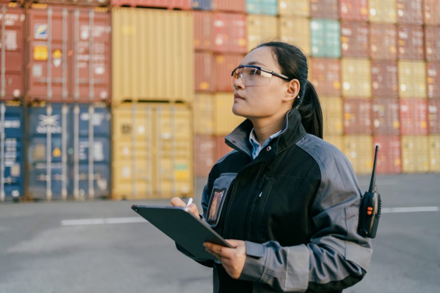 Asian Female Worker Working At Container Terminal