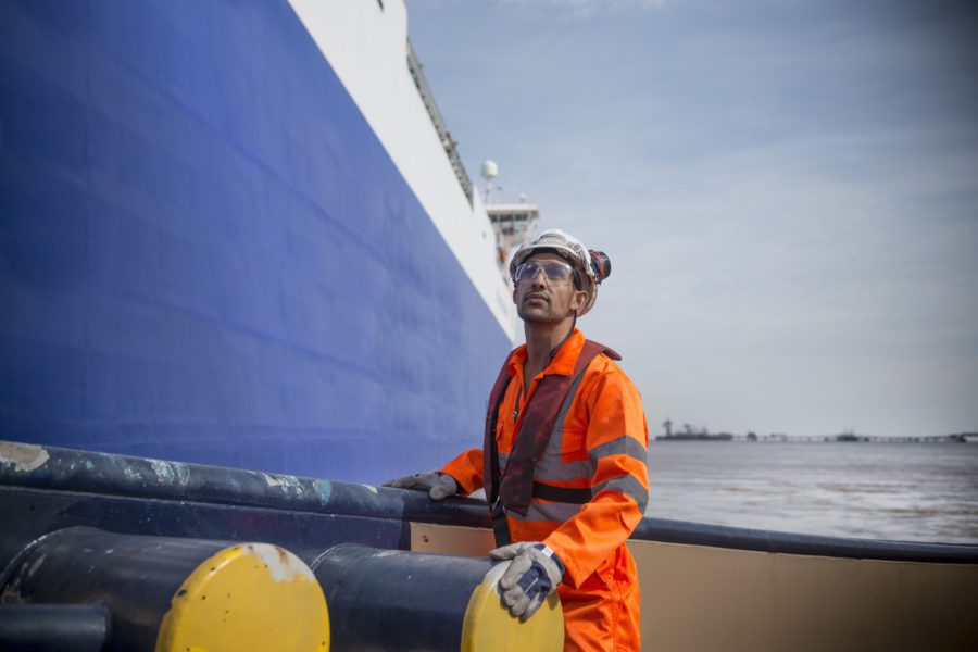 Portrait Of Tug Worker Looking Up On Tug At Sea