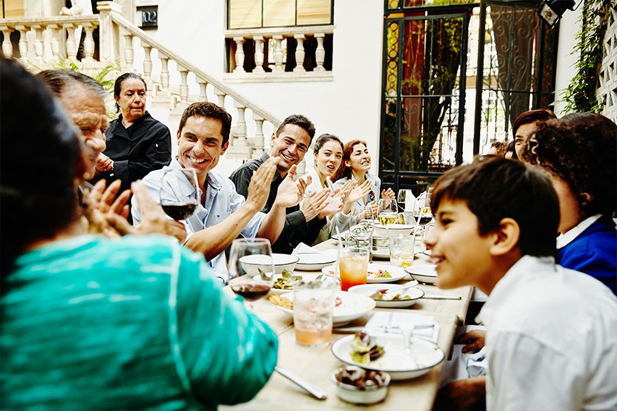 Family Celebrating At Dinner Table