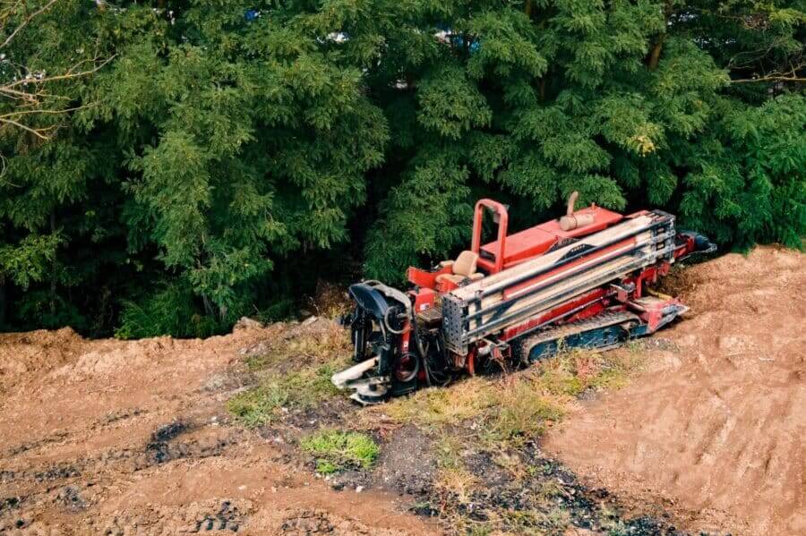 Horizontal Directional Drilling Technology. Aerial View Of Drilling Machine Work Process. Trenchless Laying Of Communications, Pipes And Water Pipes
