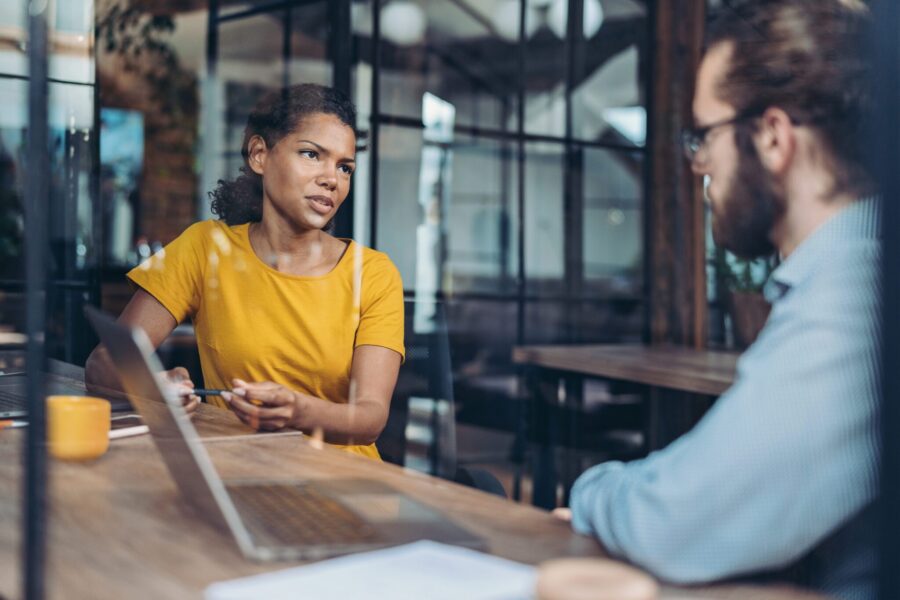 Two business persons talking in the office