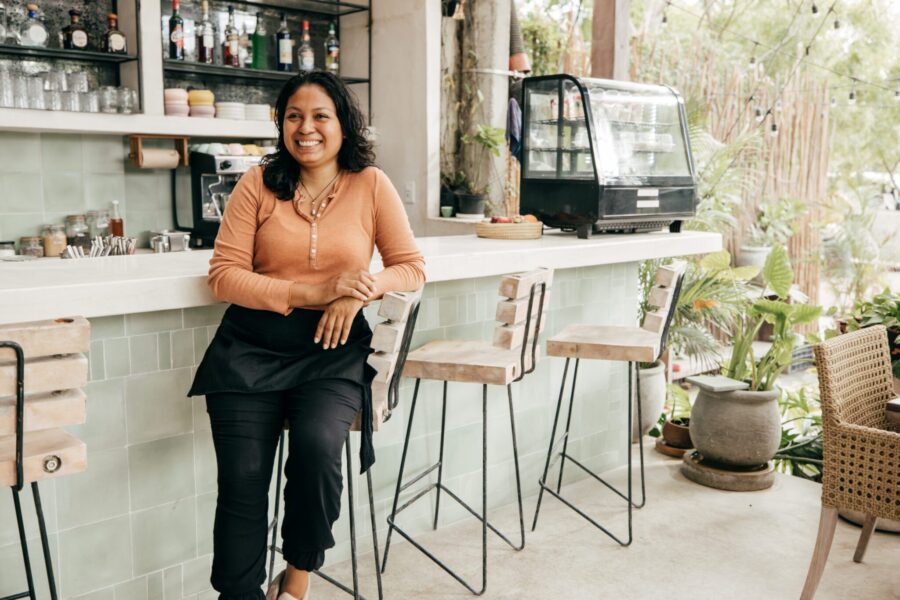 woman standing in a cafe smiling