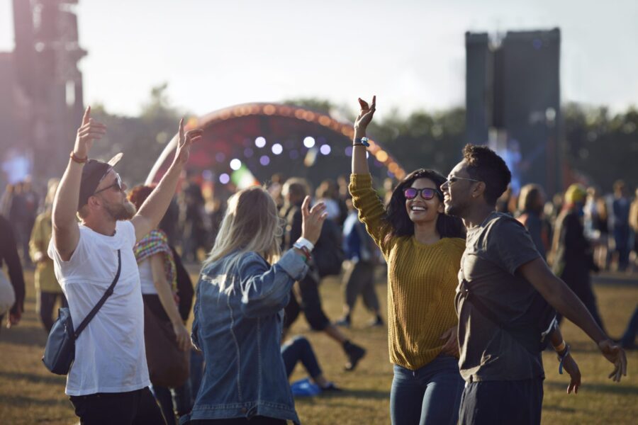 Friends hanging out at big music festival