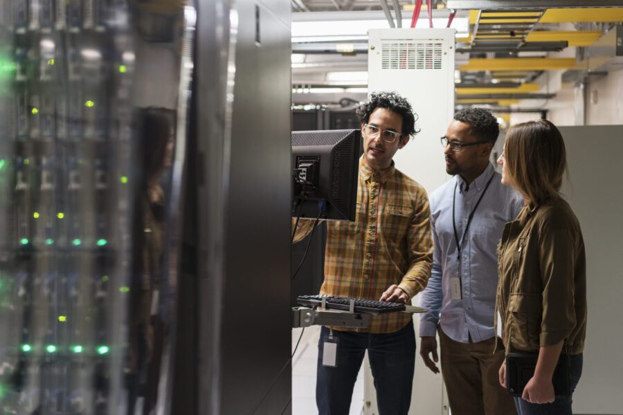 Technicians using computer in server room