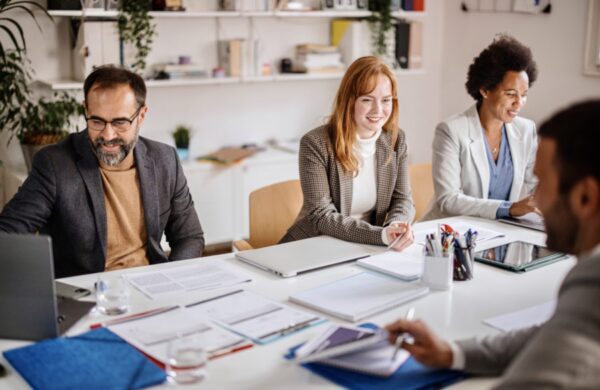 Team of corporate professionals having discussion in a meeting in conference room.