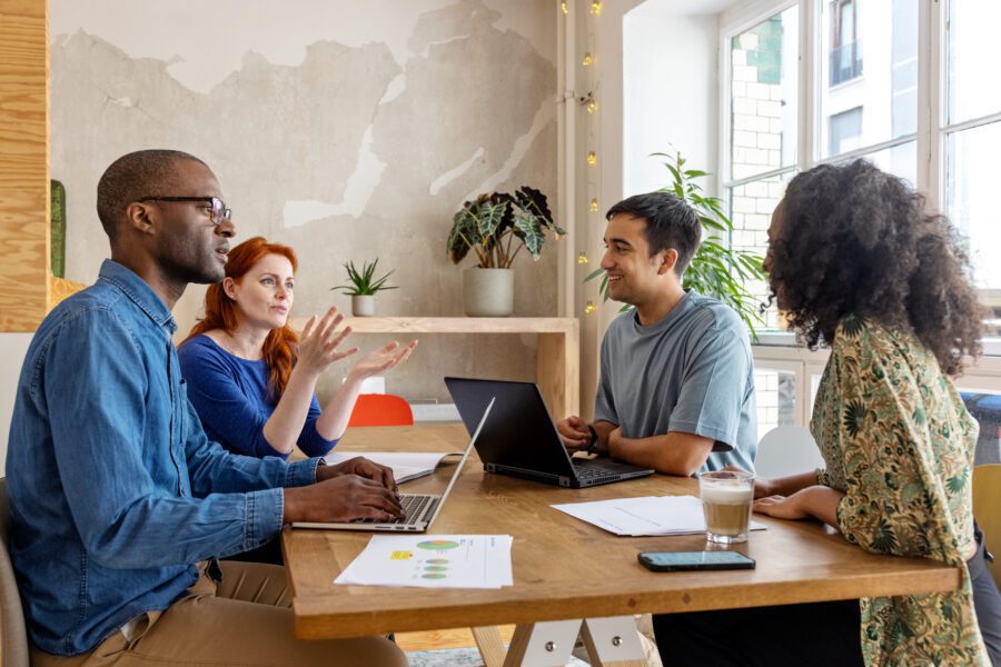 Start-up team having a meeting in office. Multiracial group of men and women discussing in office conference room