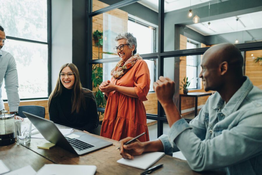 Diverse businesspeople smiling cheerfully during an office meeting