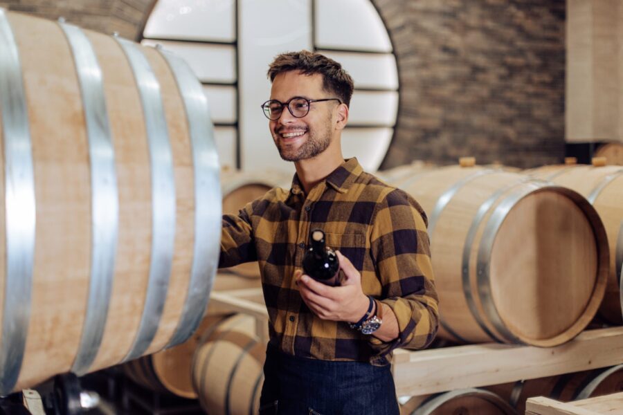 Portrait Of A Happy Craftsman Working At His Wine Cellar