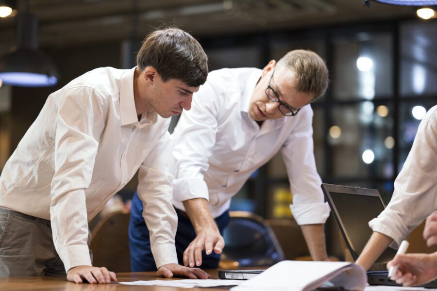 Finding Root Cause of Failure in Complex IT Projects Management.  Project Leader and Software Engineer in a meeting about root cause and back up plan in software design at a tech business office.