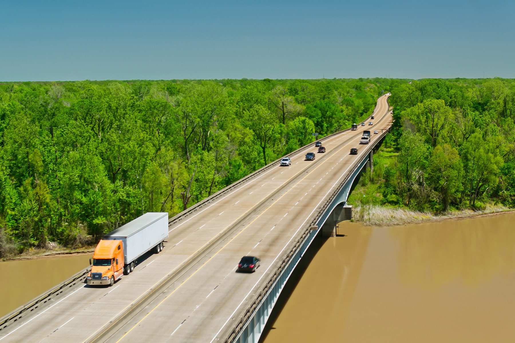 Cars driving over a bridge over a body of water