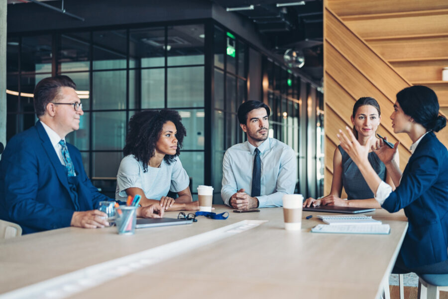 Group of entrepreneurs sitting around a table and talking