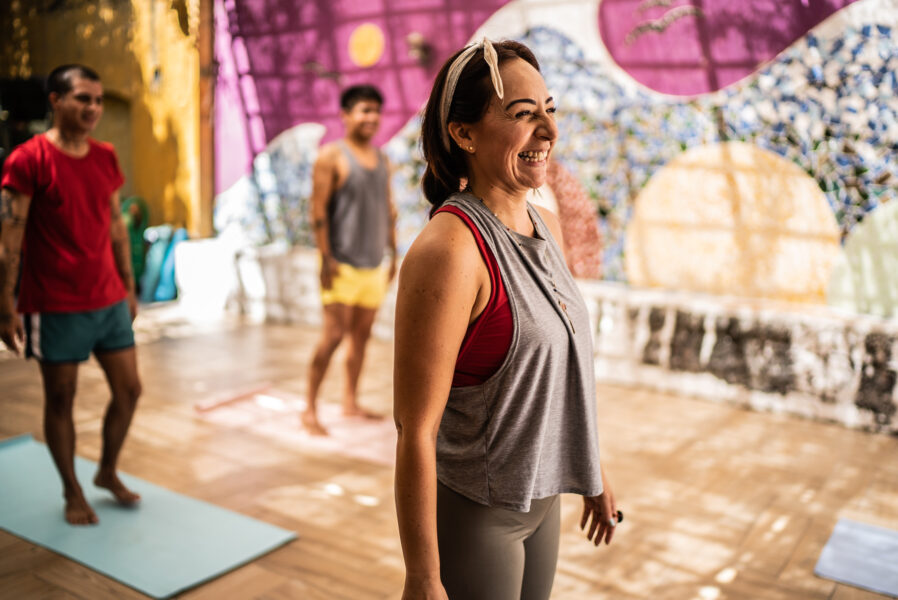 Mature woman laughing during yoga class