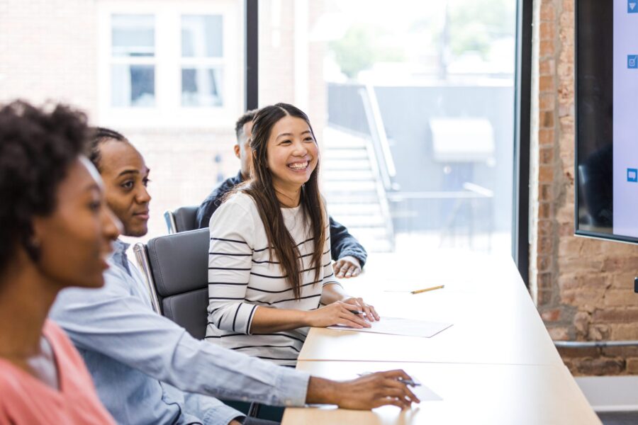 The new employees sit in the conference room and attend a welcome event that the executive team is hosting.